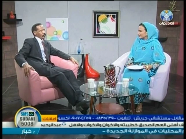 المستشار الطيب شيقوق مع المذيعة في لقاء قناة أم درمان